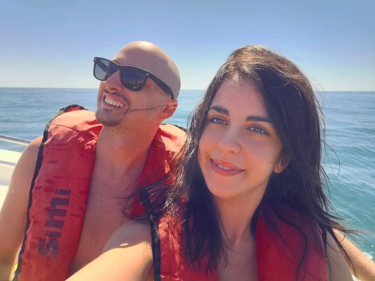 Valentina and Ivan in life jackets on a boat at sea