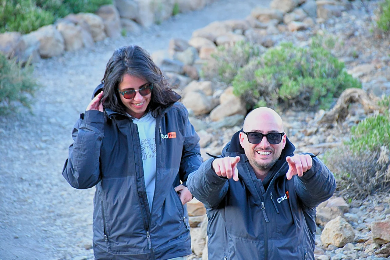 Valentina and Ivan smiling together on a rocky trail